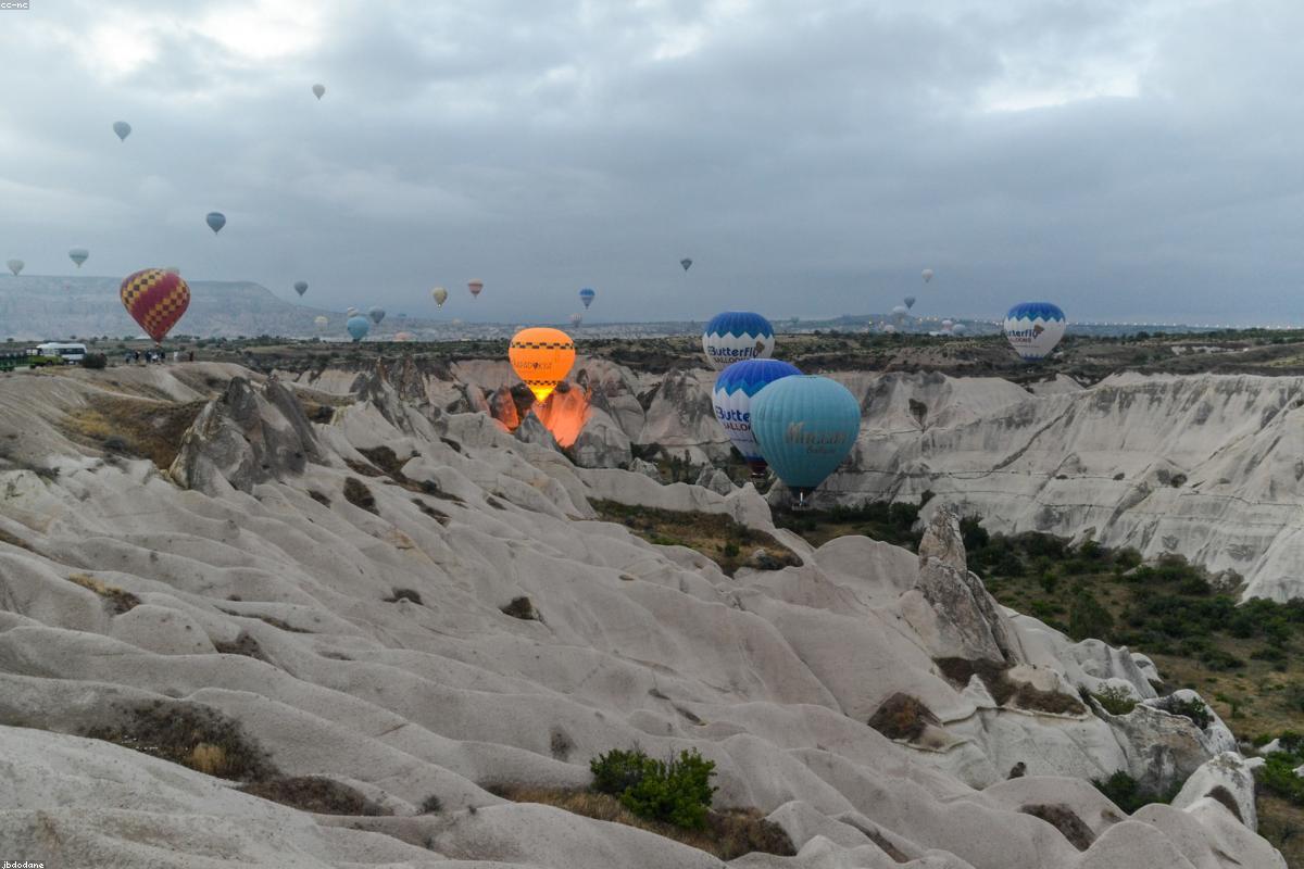 A hot air balloon in Cappadocia, Turkey, floats over the strange rocks