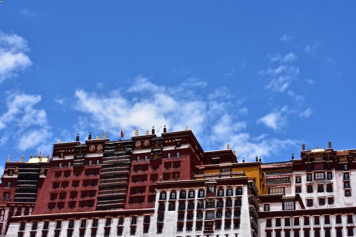 The prayer flags of the Tibetan Plateau and the snow-capped mountains shine together under the deep blue sky