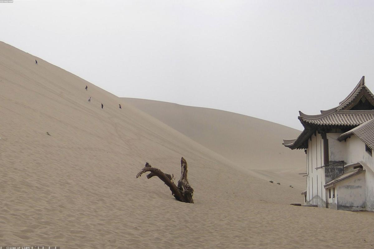 Dunhuang's Mingsha Mountain Crescent Spring desert and distant camel caravans